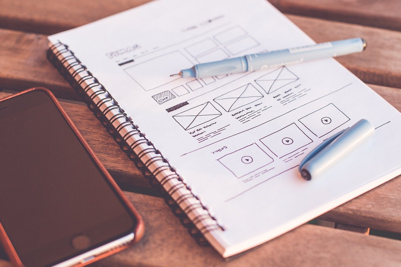 Wireframing a website design in a notebook